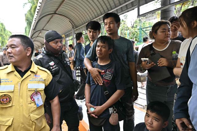 Family members of a school shooting victim react after the bodies of the deceased are carried off the premises in Bang Kruai district, Nonthaburi province, north of the Thai capital Bangkok, on August 7, 2026. A teenager described as "troubled" by a classmate killed his grandparents before gunning down at least six more people at a school in Thailand on August 7, police said. (Photo by Lillian SUWANRUMPHA / AFP)