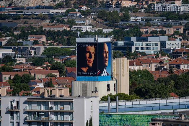 This photo shows an overview of the La Castellane neighborhood in northern Marseille, southern France, with two large-format portraits of newly appointed France head coach Zinedine Zidane, one from his youth and one recent, displayed on the facade of a building, on August 7, 2026. (Photo by Miguel MEDINA / AFP)