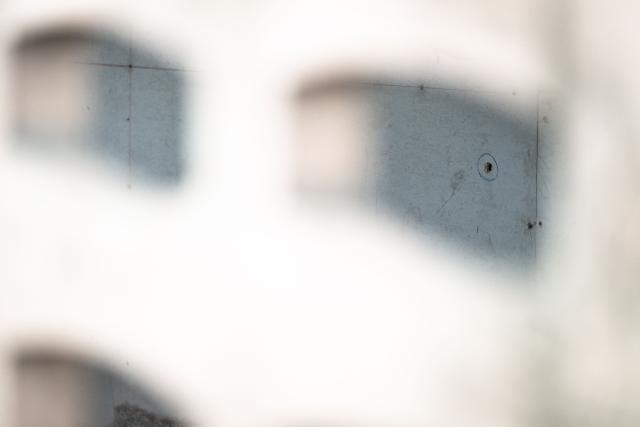 This picture shows a bullet hole in a wall at the house where a teenage suspect is suspected of killing his grandparents before carrying out a school shooting in Nonthaburi province, north of Thailand's capital Bangkok, on August 7, 2026. A teenage suspect killed his grandparents before shooting dead at least six more people at a school near Bangkok on August 7, police said. (Photo by Chanakarn LAOSARAKHAM / AFP)