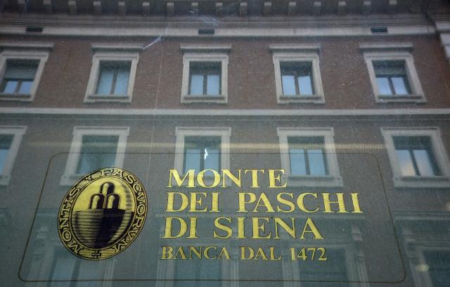 (FILES) The logo of the Monte dei Paschi di Siena bank is seen on the window of a branch in Rome on February 9, 2017. The head of Italy's Banca Monte dei Paschi di Siena has on August 7, 2026, defended its value and strategic importance, saying it would "evaluate every strategic option" as the bank fights a hostile bid from rival Intesa Sanpaolo. The world's oldest bank posted a steep rise in profit in its second quarter as Chief Executive Luigi Lovaglio warned an Intesa merger would hurt not only shareholders but the Italian economy itself. (Photo by FILIPPO MONTEFORTE / AFP)