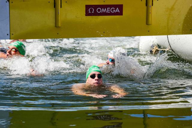 Hungary's swimmer David Betlehem arrives to win the men's 3km knockout open water swimming event during the LEN European Aquatics Championships, at the Seine River in Paris on August 7, 2026. (Photo by Dimitar DILKOFF / AFP)