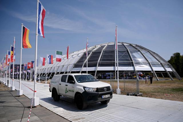 Flags of participating countries fly along the main road ahead of the annual Sziget Festival at Obuda Island, in Budapest on August 7, 2026. The 33rd Sziget Festival will take place from August 11 to 15, 2026. (Photo by Attila KISBENEDEK / AFP)