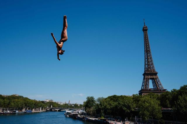 Germany's diver Maike Elena Halbisch competes in round 1 of the women’s 20m high diving event during the LEN European Aquatics Championships, alongside the Seine River, with the Eiffel Tower in background, in Paris on August 7, 2026. (Photo by Dimitar DILKOFF / AFP)