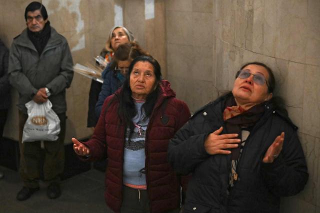 Women pray at the Saint Cajetan Church, patron saint of work and bread, in Buenos Aires on August 7, 2026. Every year on the feast of Saint Cajetan, thousands of Catholics visit the shrine to pay homage to the saint and pray for employment and prosperity. (Photo by Luis ROBAYO / AFP)