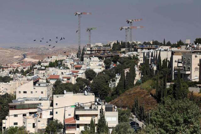 Construction cranes operate in the Israeli settlement of Pisgat Zeev, built in a suburb of the predominantly-Arab and Israeli-annexed East Jerusalem on August 7, 2026. Excluding east Jerusalem, which was occupied and annexed by Israel in 1967, some 500,000 Israeli settlers live in the West Bank, along with about three million Palestinian residents. All Israeli settlements in the West Bank are illegal under international law. (Photo by AHMAD GHARABLI / AFP)
