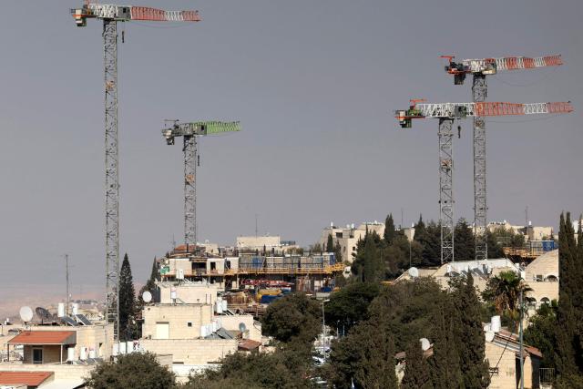 Construction cranes operate in the Israeli settlement of Pisgat Zeev, built in a suburb of the predominantly-Arab and Israeli-annexed East Jerusalem on August 7, 2026. Excluding east Jerusalem, which was occupied and annexed by Israel in 1967, some 500,000 Israeli settlers live in the West Bank, along with about three million Palestinian residents. All Israeli settlements in the West Bank are illegal under international law. (Photo by AHMAD GHARABLI / AFP)