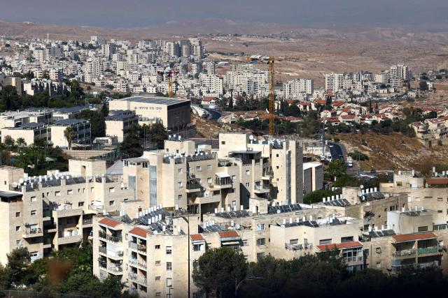 The Israeli settlement of Pisgat Zeev (foreground) in the northern area of east Jerusalem and Israel's controversial barrier separating the Palestinian town Hzma (background) are pictured in the occupied West Bank  on August 7, 2026. Excluding east Jerusalem, which was occupied and annexed by Israel in 1967, some 500,000 Israeli settlers live in the West Bank, along with about three million Palestinian residents. All Israeli settlements in the West Bank are illegal under international law. (Photo by AHMAD GHARABLI / AFP)