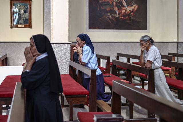 This picture taken on June 22, 2026 shows Catholic nuns and Christian worshippers attend mass at the Latin Monastery (Deir al-Latin) in the Palestinian Christian town of Taybeh, northeast of the city of Ramallah in the Israeli-occupied West Bank. Christians of the West Bank are concentrated in Israeli-annexed east Jerusalem and Bethlehem, as well as Ramallah and several surrounding villages and towns. In the town of Taybeh, east of Ramallah -- the last entirely Christian town in the West Bank -- churches have documented the emigration of more than 15 families since 2023. Its population, now 1,200, stood at 3,000 in the 1980s. (Photo by Zain JAAFAR / AFP) / To go with 'PALESTINIAN-ISRAEL-CONFLICT-CHRISTIANITY, FOCUS by Imad FREIJ