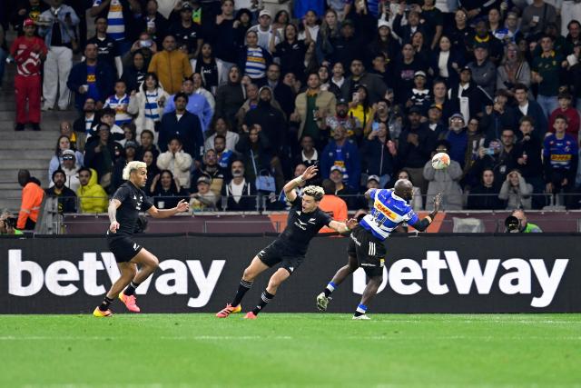 Stormers' South African wing Seabelo Senatla wins a high ball against New Zealand's wing Rieko Ioane during a rugby union tour match between the Stormers and New Zealand at the Cape Town Stadium in Cape Town on August 7, 2026. (Photo by Rodger Bosch / AFP)