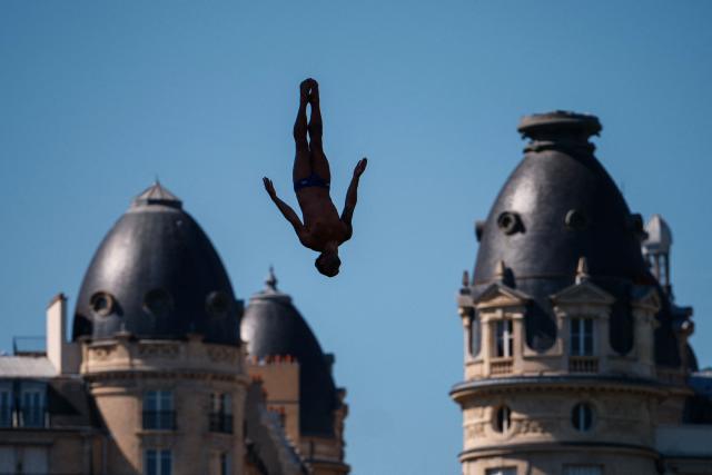 Spain's Carlos Javier Gimeno Martinez competes in the men’s 20m high diving event during the LEN European Aquatics Championships, alongside the Seine River, in Paris on August 7, 2026. (Photo by Dimitar DILKOFF / AFP)