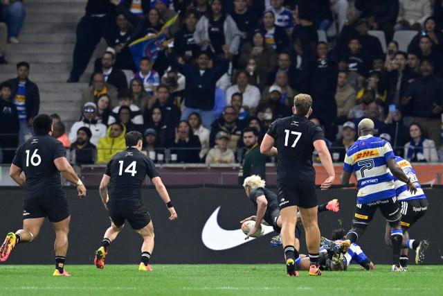 New Zealand's wing Rieko Ioane dives across the line to score a try during a rugby union tour match between the Stormers and New Zealand at the Cape Town Stadium in Cape Town on August 7, 2026. (Photo by Rodger Bosch / AFP)