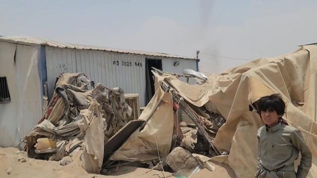 This frame grab taken from AFPTV video footage on August 7, 2026, shows a boy standing near the damage at Mail al-Saila internally displaced camp (IDP) on the outskirts of Marib following a reported Houthi ballistic missile attack on the government-held city of Marib early August 7, amid an escalation in hostilities. The strategic province of Marib is split between the Houthis and the government, which controls the city of Marib as well as the surrounding oil fields and facilities. (Photo by AFPTV / AFP) / 