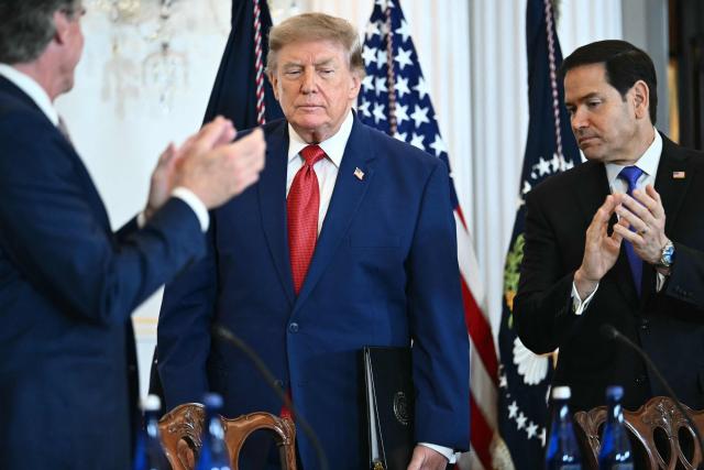US President Donald Trump is applauded by US Secretary of the Interior Doug Burgum (L) and US Secretary of State Marco Rubio as he arrive to participate in a roundtable on the American mining industry at the US Department of State in Washington, DC, on August 7, 2026. (Photo by Kent NISHIMURA / AFP)