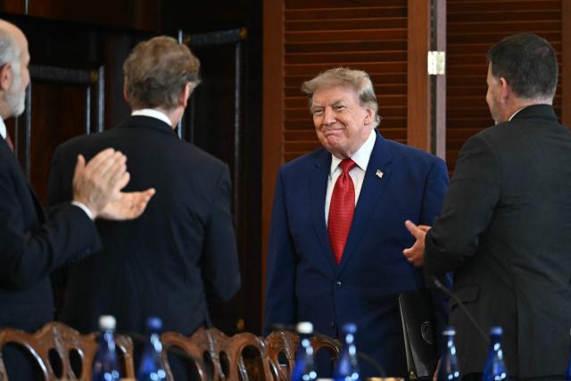 US President Donald Trump is applauded as he arrives to participate in a roundtable on the American mining industry at the US Department of State in Washington, DC, on August 7, 2026. (Photo by Kent NISHIMURA / AFP)
