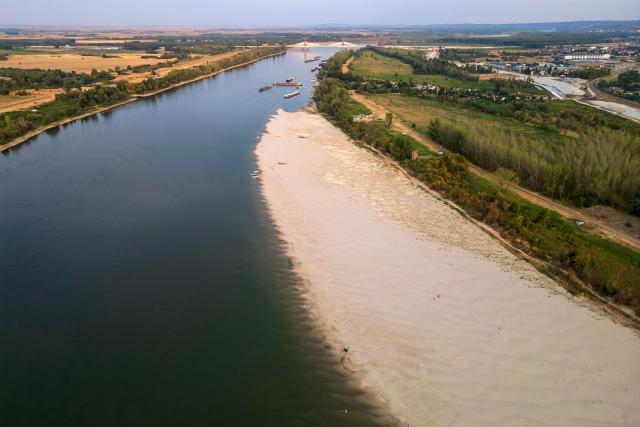 This aerial photo shows a sandbar exposed by the low water level of the Danube River near Novi Sad, Serbia, on August 7, 2026, as prolonged hot and dry weather continues to lower water levels across the country. Scientists say global warming is increasing droughts and causing weather emergencies to become more extreme and more frequent. Prolonged drought and hot weather across Europe have pushed water levels along the Danube river to record seasonal lows, reaching its lowest flow rate in the last 30 years. (Photo by Andrej ISAKOVIC / AFP)