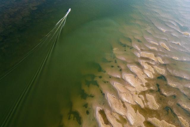 This aerial photo shows sandbars exposed by the low water level of the Danube River near Novi Sad, Serbia, on August 7, 2026, as prolonged hot and dry weather continues to lower water levels across the country. Scientists say global warming is increasing droughts and causing weather emergencies to become more extreme and more frequent. Prolonged drought and hot weather across Europe have pushed water levels along the Danube river to record seasonal lows, reaching its lowest flow rate in the last 30 years. (Photo by Andrej ISAKOVIC / AFP)