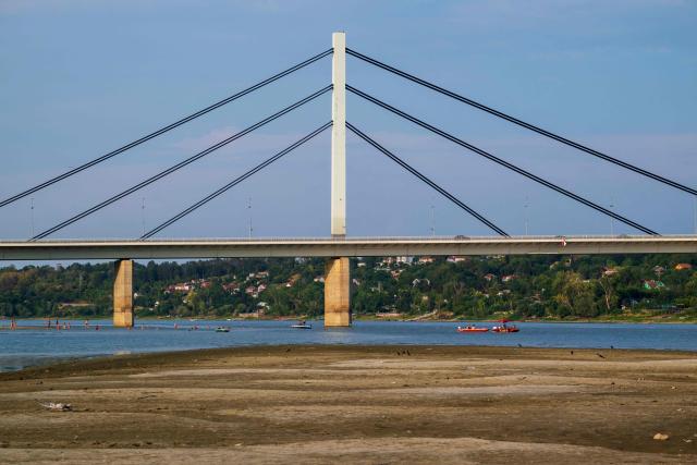 This photograph shows a sandbar exposed by the low water level of the Danube River in Novi Sad, Serbia, on August 7, 2026, as prolonged hot and dry weather continues to lower water levels across the country. Scientists say global warming is increasing droughts and causing weather emergencies to become more extreme and more frequent. Prolonged drought and hot weather across Europe have pushed water levels along the Danube river to record seasonal lows, reaching its lowest flow rate in the last 30 years. (Photo by Andrej ISAKOVIC / AFP)