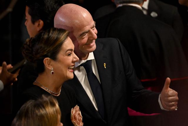 FIFA's president Gianni Infantino poses with an attendee to the swearing-in ceremony of Colombia's new President Abelardo de la Espriella at Universidad Santiago de Cali in Cali, Colombia, on August 7, 2026. (Photo by Luis ACOSTA / AFP)