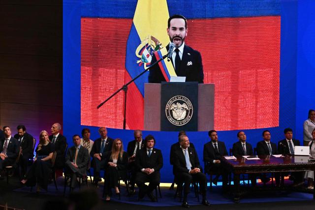 Guests at Universidad Santiago de Cali watch Colombia's new President Abelardo de la Espriella deliver a speech from the Pichincha Battalion in Cali on a giant screen during his inauguration ceremony in Cali, Colombia, on August 7, 2026. (Photo by Luis ACOSTA / AFP)