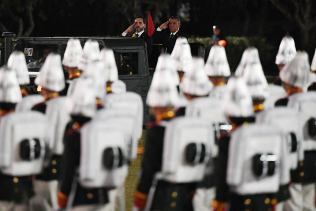 Colombia's new President Abelardo de la Espriella (L) rides in a military vehicle while reviewing troops during a change-of-command ceremony at the Pichincha Battalion following his inauguration in Cali, Colombia, on August 7, 2026. (Photo by Jaime SALDARRIAGA / AFP)