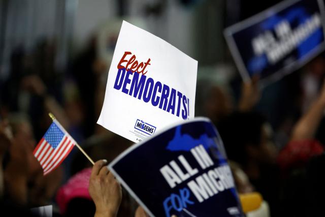 Democratic Party supporters hold campaign signs during the Michigan Democratic Party General Election Kickoff Rally at Renaissance High School in Detroit, Michigan, on August 7, 2026. (Photo by JEFF KOWALSKY / AFP)