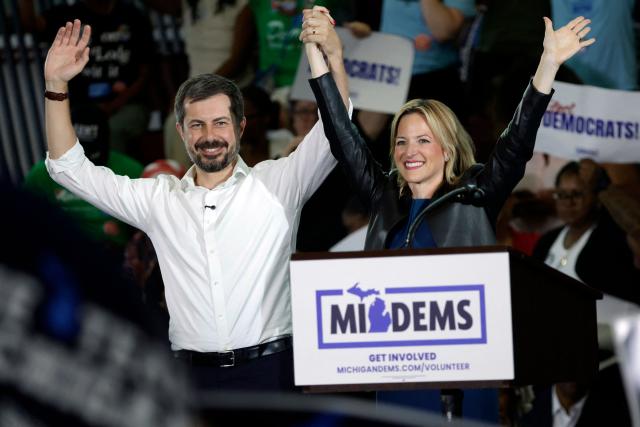 Michigan Secretary of State and gubernatorial candidate Jocelyn Benson (R) is joined on the stage by former US Secretary of Transportation Pete Buttigieg during the Michigan Democratic Party General Election Kickoff Rally at Renaissance High School in Detroit, Michigan, on August 7, 2026. (Photo by JEFF KOWALSKY / AFP)