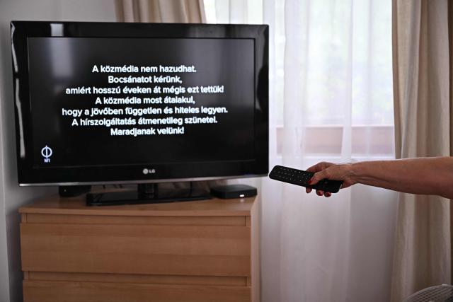 (FILES) A message can be read on a tv screen at a family home in Agard, Hungary on July 7, 2026, as the main state channel, the M1 informs viewers of the temporary suspension of news broadcasts in all state broadcasters. A month after Hungary's state broadcaster has halted transmissions of news programmes, many employees spend days at home, waiting to learn when -- or if -- they can return to work.
The reorganisation of public media was a key campaign pledge for pro-EU Prime Minister Peter Magyar, who ousted nationalist Viktor Orban at the April elections, promising a "system change". (Photo by Attila KISBENEDEK / AFP)