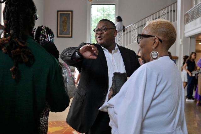Pastor Dr. J. Lawrence Turner (C) speaks with congregants following Sunday service at Mississippi Boulevard Christian Church in Memphis, Tennessee, on August 2, 2026. Like every Saturday during election season, the Black Clergy Collaborative, an organization that brings together dozens of Black churches in Memphis, organizes door-to-door campaigns in the city’s African American neighborhoods to encourage residents to vote. The city’s Black clergy, in the place where Martin Luther King was assassinated in 1968, is redoubling its efforts to mobilize African American voters, in the hope of sending a Democratic representative to the United States Congress. (Photo by Brandon DILL / AFP)