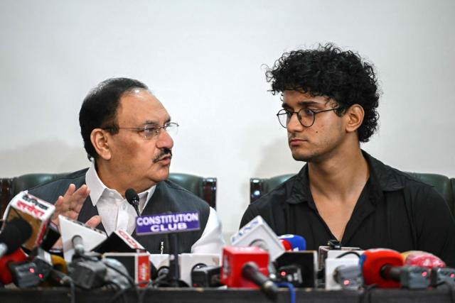 (FILES) Cockroach Janta Party (CJP) spokesperson Saurav Das (R) and India's Health Minister JP Nadda attend a press conference after their meeting in New Delhi on July 25, 2026, following the resignation of the country's Education Minister Dharmendra Pradhan amid an ongoing protest at Jantar Mantar over alleged NEET examination irregularities. Two weeks after youth-led protests forced India's education minister to resign, Prime Minister Narendra Modi's government is grappling with the fallout from one of its toughest political challenges in years. Led by the online Cockroach Janta Party (CJP), the demonstrations spread from New Delhi to other cities, broadening from anger over exam irregularities into a wider movement over unemployment, opportunities for young people and what critics describe as Modi's increasingly authoritarian rule. (Photo by Arun SANKAR / AFP)