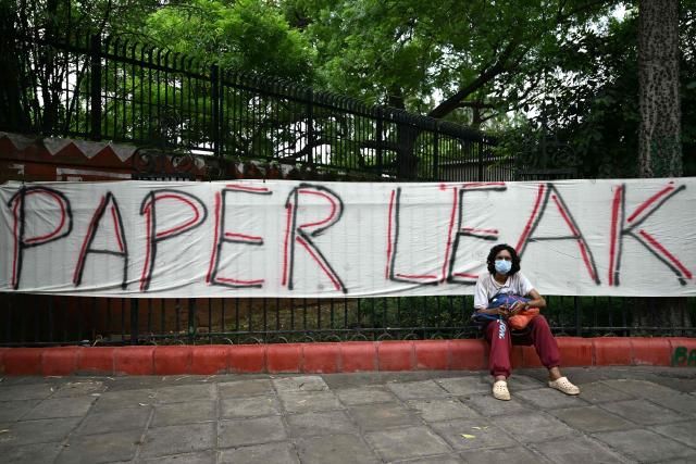 (FILES) A Cockroach Janta Party (CJP) supporter sits at Jantar Mantar in New Delhi on July 23, 2026 during the ongoing protest to demand the resignation of India's Education Minister Dharmendra Pradhan over alleged NEET exam irregularities. Two weeks after youth-led protests forced India's education minister to resign, Prime Minister Narendra Modi's government is grappling with the fallout from one of its toughest political challenges in years. Led by the online Cockroach Janta Party (CJP), the demonstrations spread from New Delhi to other cities, broadening from anger over exam irregularities into a wider movement over unemployment, opportunities for young people and what critics describe as Modi's increasingly authoritarian rule. (Photo by Sajjad HUSSAIN / AFP)