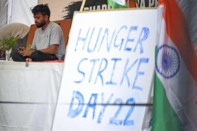(FILES) Cockroach Janta Party (CJP) founder Abhijeet Dipke sits on an indefinite hunger strike demanding the resignation of India's Education Minister Dharmendra Pradhan over alleged NEET examination irregularities in New Delhi on July 19, 2026. Two weeks after youth-led protests forced India's education minister to resign, Prime Minister Narendra Modi's government is grappling with the fallout from one of its toughest political challenges in years. Led by the online Cockroach Janta Party (CJP), the demonstrations spread from New Delhi to other cities, broadening from anger over exam irregularities into a wider movement over unemployment, opportunities for young people and what critics describe as Modi's increasingly authoritarian rule. (Photo by Sajjad HUSSAIN / AFP)