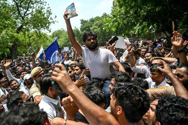 (FILES) Cockroach Janta Party (CJP) founder Abhijeet Dipke (C) takes part in a protest over alleged irregularities in the country's major examinations, in New Delhi on June 6, 2026. Two weeks after youth-led protests forced India's education minister to resign, Prime Minister Narendra Modi's government is grappling with the fallout from one of its toughest political challenges in years. Led by the online Cockroach Janta Party (CJP), the demonstrations spread from New Delhi to other cities, broadening from anger over exam irregularities into a wider movement over unemployment, opportunities for young people and what critics describe as Modi's increasingly authoritarian rule. (Photo by Arun SANKAR / AFP)