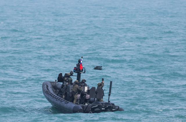 Taiwanese soldiers operate a surveillance drone from an M109 Special assault boat as part of annual Han Kuang military exercises at a navy base in Kaohsiung on August 8, 2026. (Photo by I-Hwa Cheng / AFP)