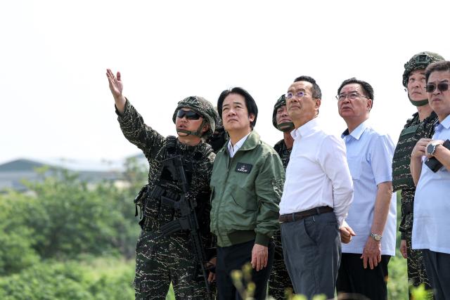 Taiwan's President Lai Ching-te (2nd-L) and Defence Minister Wellington Koo (3rd-L) inspect a drone operation at a navy base during annual Han Kuang military exercise in Kaohsiung on August 8, 2026. (Photo by I-Hwa Cheng / AFP)