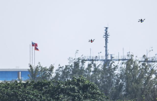 Two Taiwanese military attack drones fly over a beach during a combat drill as part of the annual Han Kuang military exercises at a navy base in Kaohsiung on August 8, 2026. (Photo by I-Hwa Cheng / AFP)