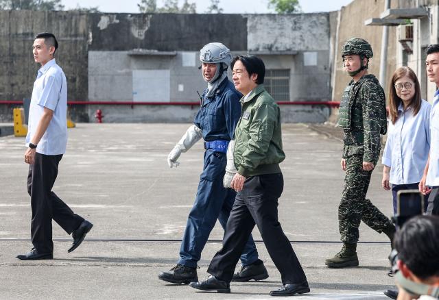 Taiwan's President Lai Ching-te (C) prepares to board a Kuang Hua VI-class missile boat during the annual Han Kuang military exercises at a naval base in Kaohsiung on August 8, 2026. (Photo by I-Hwa Cheng / AFP)