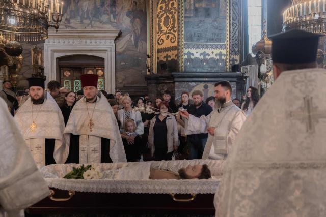 EDITORS NOTE: Graphic content / Ukrainian priests conduct the funeral service of Oleksiy Yukov, head of the Ukrainian platsdarm search unit, at the St. Volodymyr's Cathedral in Kyiv on August 8, 2026, amid the Russian invasion of Ukraine. For years, Oleksiy Yukov walked the boundary between the living and the dead as he led a group of volunteers retrieving corpses in the most dangerous parts of Ukraine's front. He was killed on August 5, 2026 during what would be his last search mission, the news of his death triggering an outpour of grief, especially in the eastern Ukraine, where he had become a familiar figure, often appearing in the moments of grief that have come to define life the Donetsk region, battered by years of Russian assaults. (Photo by Roman PILIPEY / AFP)