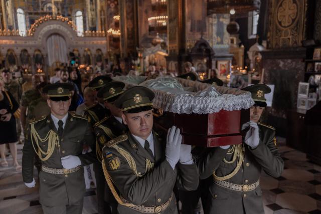 Ukrainian military members carry the coffin of Oleksiy Yukov, head of the Ukrainian platsdarm search unit, during his funeral at the St. Volodymyr's Cathedral in Kyiv on August 8, 2026, amid the Russian invasion of Ukraine. For years, Oleksiy Yukov walked the boundary between the living and the dead as he led a group of volunteers retrieving corpses in the most dangerous parts of Ukraine's front. He was killed on August 5, 2026 during what would be his last search mission, the news of his death triggering an outpour of grief, especially in the eastern Ukraine, where he had become a familiar figure, often appearing in the moments of grief that have come to define life the Donetsk region, battered by years of Russian assaults. (Photo by Roman PILIPEY / AFP)