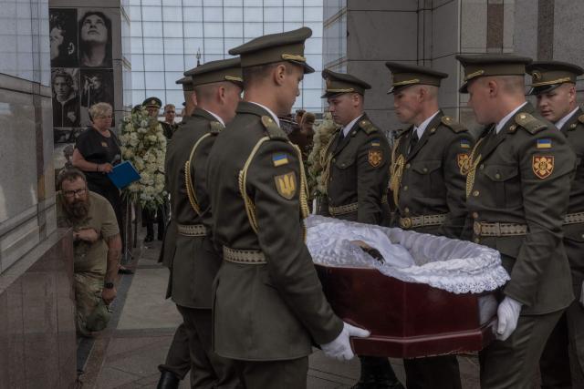 EDITORS NOTE: Graphic content / Ukrainian military members carry the coffin of Oleksiy Yukov, head of the Ukrainian platsdarm search unit, during his funeral in Independence Square in Kyiv on August 8, 2026, amid the Russian invasion of Ukraine. For years, Oleksiy Yukov walked the boundary between the living and the dead as he led a group of volunteers retrieving corpses in the most dangerous parts of Ukraine's front. He was killed on August 5, 2026 during what would be his last search mission, the news of his death triggering an outpour of grief, especially in the eastern Ukraine, where he had become a familiar figure, often appearing in the moments of grief that have come to define life the Donetsk region, battered by years of Russian assaults. (Photo by Roman PILIPEY / AFP)
