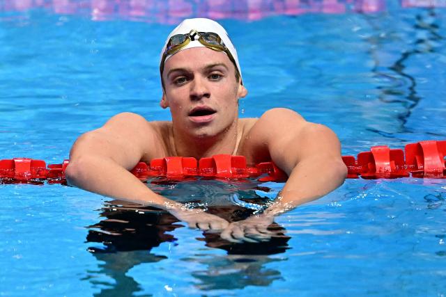 (FILES) France's swimmer Leon Marchand reacts after the final of the men's 4x200m freestyle relay swimming event during the 2025 World Aquatics Championships in Singapore on August 1, 2025. Leon Marchand has withdrawn from the 200m and 400m individual medley swimming events of the LEN European Aquatics Championships due to insufficient recovery from an adductor muscle injury, the French Swimming Federation announced in a statement on August 8, 2026. Swimming events of the European Aquatics Championships are held from August 10 to 16. (Photo by MANAN VATSYAYANA / AFP)