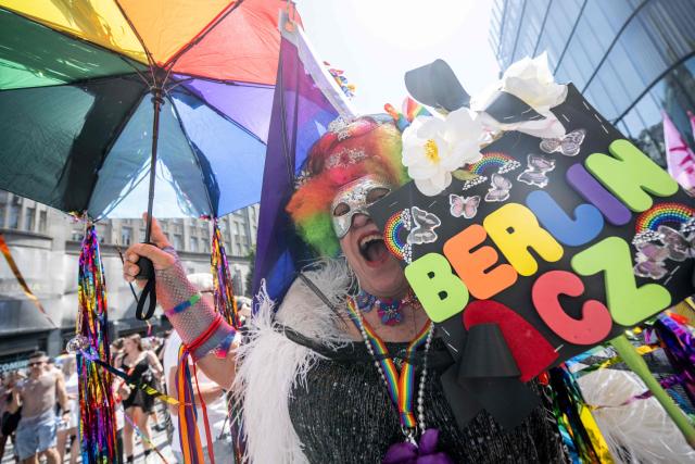 A participant with a rainbow umbrella reacts during the Prague Pride parade in Prague, Czech Republic on August 8, 2026.  (Photo by Michal Cizek / AFP)