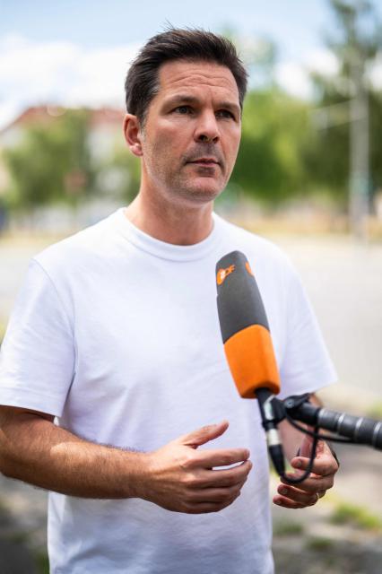 Steffen Krach, the Social Democratic Party's (SPD) main candidate in upcoming regional elections in Berlin, speaks to reporters during a campaign stop in Berlin's Wedding district on August 8, 2026. Berlin goes to the polls on September 20, 2026. (Photo by John MACDOUGALL / AFP)