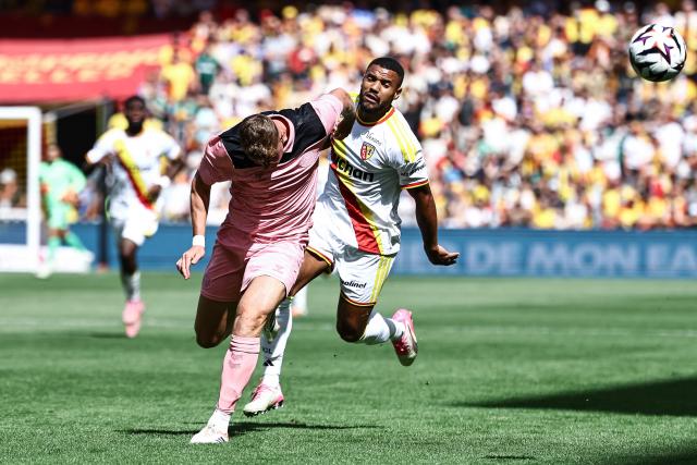 Sunderland's Northern Irish midfielder #05 Daniel Ballard (L) fights for the ball with Lens' French defender Matthieu Udol (R) during the friendly football match between RC Lens and AFC Sunderland at the Bollaert-Delelis Stadium in Lens, northern France, on August 8, 2026. (Photo by Sameer Al-DOUMY / AFP)