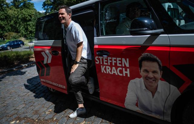 Steffen Krach, the Social Democratic Party's (SPD) main candidate in upcoming regional elections in Berlin, steps out of his campaign van during a campaign stop in Berlin's Pankow district on August 8, 2026. Berlin goes to the polls on September 20, 2026. (Photo by John MACDOUGALL / AFP)