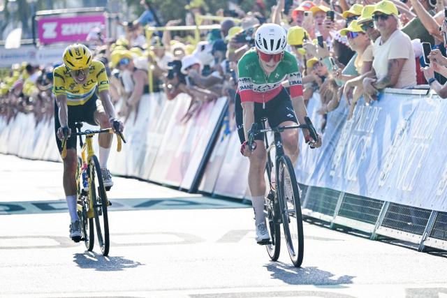 UAE Team ADQ's Italian rider Elisa Longo Borghini (R) and Canyon//SRAM zondacrypto's Polish rider Katarzyna Niewiadoma, wearing the overall leader's yellow jersey, cross the finish line during the 8th (out of 9) stage of the fifth edition of the Women's Tour de France cycling race, 171.9 km from Sisteron to Nice, in Nice, southeastern France on August 8, 2026. (Photo by NICOLAS TUCAT / AFP)