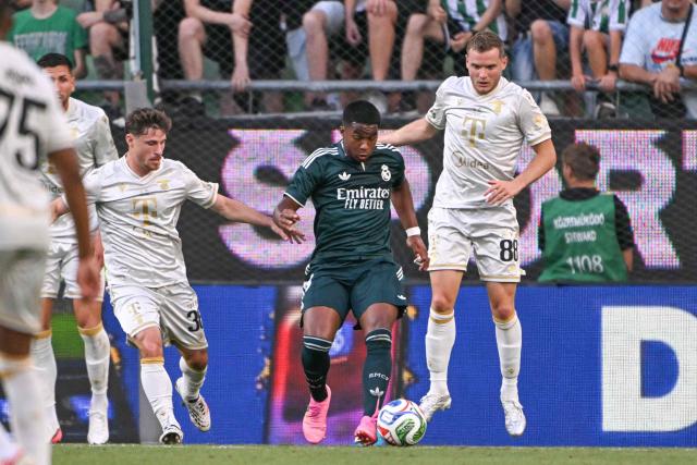 Real Madrid's Brazilian forward #29 Endrick (C), Ferencvaros' Belgian midfielder #88 Philippe Rommens (R) and Ferencvaros' Israeli midfielder #36 Gavriel Kanichowsky vie for the ball during the pre-season football match between Ferencvaros and Real Madrid in Budapest, Hungary on August 8, 2026. Real Madrid on August 6, 2026 announced a new six-year deal for star forward Vinicius Junior and the signing of teenage sensation Yan Diomande in a major boost to their quest to end a two-year trophy drought. (Photo by Attila KISBENEDEK / AFP)