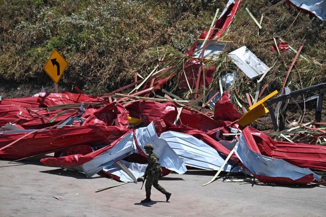 A soldier stands guard after a toll plaza was attacked in Santander de Quilichao, Cauca department, Colombia, on August 8, 2026. (Photo by Joaquin SARMIENTO / AFP)
