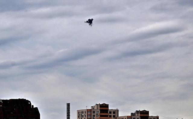 This photograph shows an explosion as Ukrainian air defence shoot down a drone above Kyiv during an attack on the Ukrainian capital on August 8, 2026 amid the Russian invasion of Ukraine. (Photo by Sergei SUPINSKY / AFP)