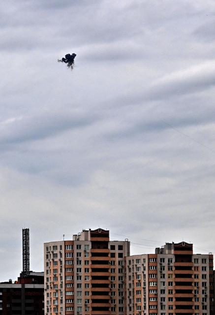 This photograph shows an explosion as Ukrainian air defence shoot down a drone above Kyiv during an attack on the Ukrainian capital on August 8, 2026 amid the Russian invasion of Ukraine. (Photo by Sergei SUPINSKY / AFP)