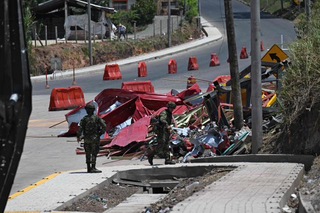 Soldiers stand guard after a toll plaza was attacked in Santander de Quilichao, Cauca department, Colombia, on August 8, 2026. (Photo by Joaquin SARMIENTO / AFP)
